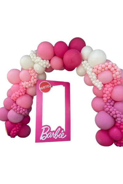 A super jumbo luxe organic balloon arch in Barbie themed colors with a barbie cutout in front designed by Loononna, Orlando, FL