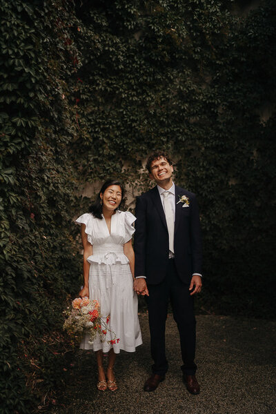 bride and groom laughing at the camera at their Melbourne Wedding