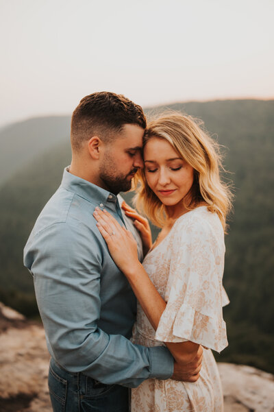 man kissing woman's cheek