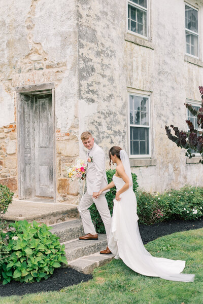 Bride and groom walking up steps at their Maryland golf course wedding