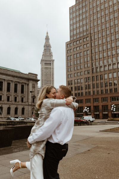 A newly engaged couple embraces in the middle of the city in Washington, DC