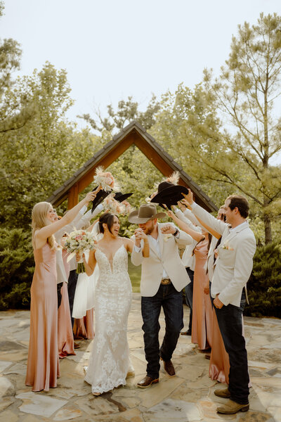 wedding party portrait with couple in the middle of their friends