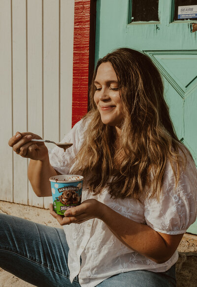 photograher eating ben and jerry's ice cream