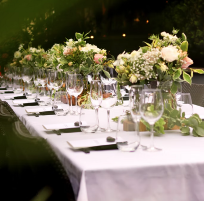 Wine glasses and floral arrangements on a wedding reception table