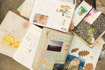 A pile of open travel journals