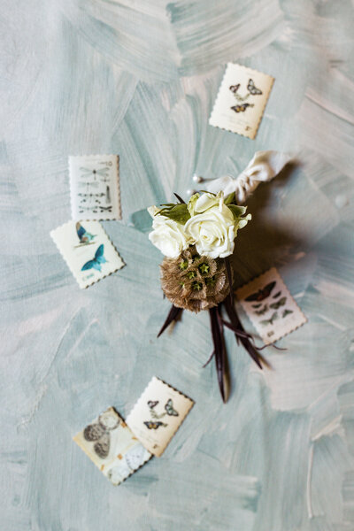 A timeless flat lay of a groom’s boutonniere captured by Greenville wedding photographer Dani Lacey Photographs. Editorial wedding detail photography highlighting floral design, styling, and elegant textures for wedding photo timelines.
