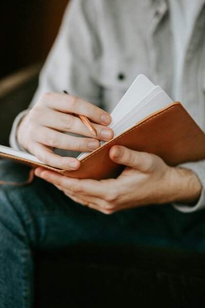Man flipping through a notebook