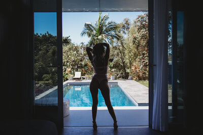 woman in a boudoir photo in front of the pool