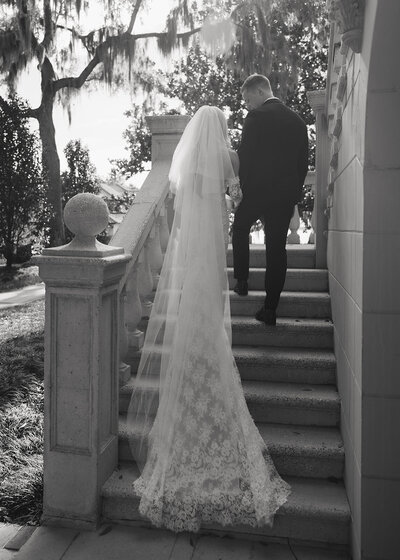 bride and groom walk up stairs in Jacksonville, FL