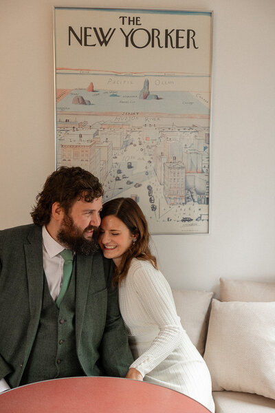 wedding couple at home photos in kitchen with New Yorker poster