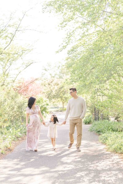 family walking during outdoor maternity photo in Ashburn, Virginia