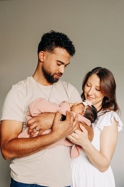 couple with their newborn baby girl during a newborn photo session