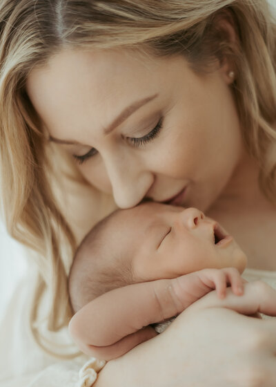 Photo of wall art in the bedroom of Dad holding his sleeping baby on his chest.