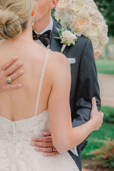 Bride and Groom kissing, holding each other close in a moment of embrace