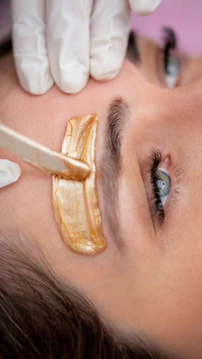 a woman getting her brow waxed