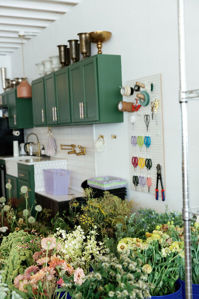 Organic growing floral installation, ceremony floating arch, floral hues of peach, pink, purple, and natural greenery. Design by Rosemary and Finch in downtown Nashville, TN.