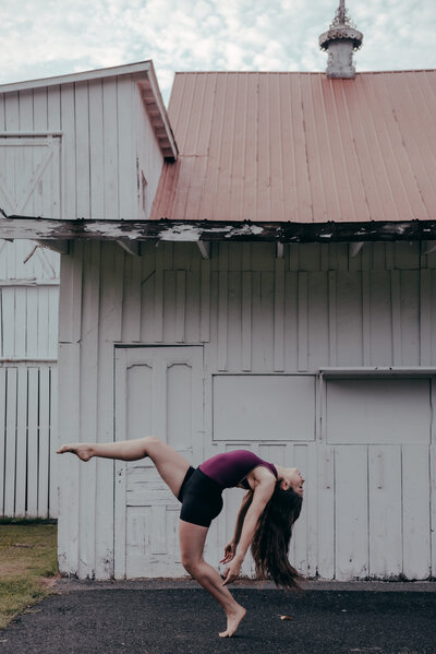 dancer jumps in downtown Frederick alley with hair flying dc dancer