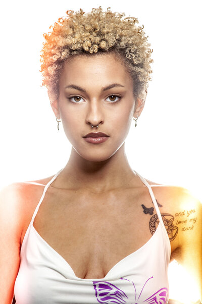 black woman with curly blonde hair headshot