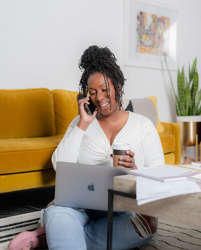 baltimore virtual cfo talking on her cellphone while holding her coffee