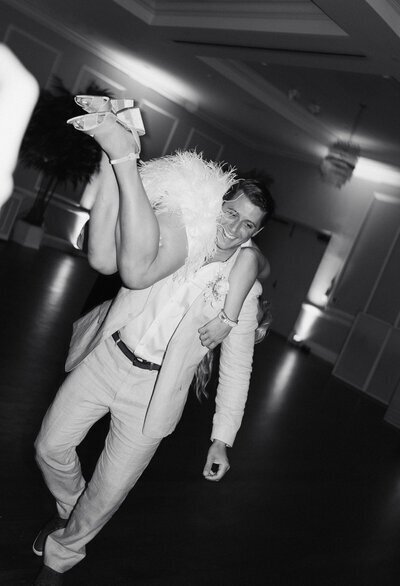 Groom carrying bride on shoulder taken by best wedding photographers in jacksonville fl Shelby Ann Photos