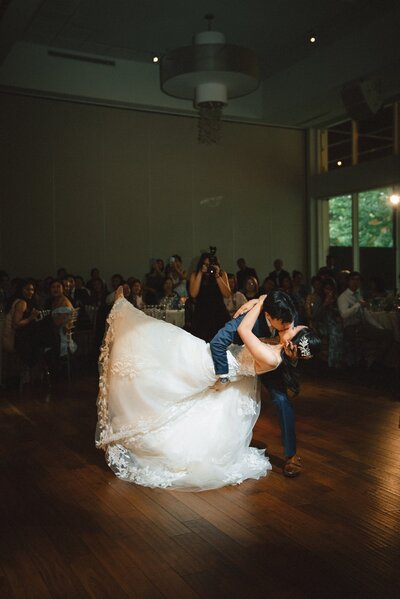Groom dipping bride on the dance floor