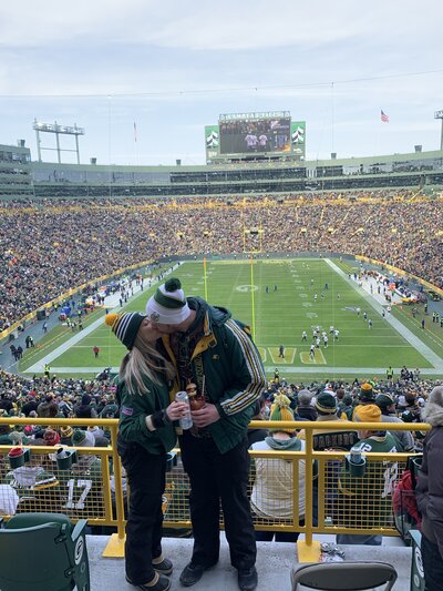 Liz Wisconsin wedding planner at a Green Bay Packer game with her husband.