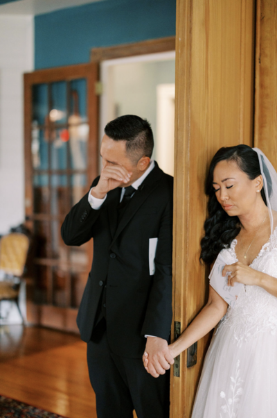 Bride and groom pray together before their wedding Mass in Pensacola, FL.