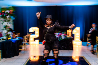 Capture the energy of your 21st birthday with this fun photoshoot of a black woman dancing and celebrating her big day.
