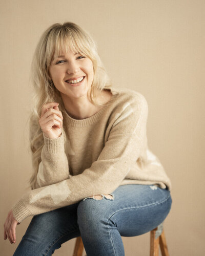 Actor and producer Cassi smiling in a headshot. 