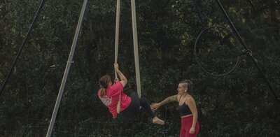 Aerial Coach Lexis Potter during an outdoor hammock lesson.