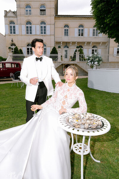 Couple eating oysters in front of No3 the Chateau southern France