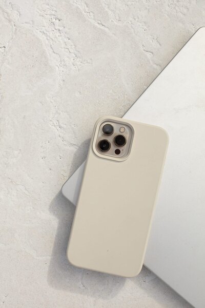 An iPhone laying on a laptop.