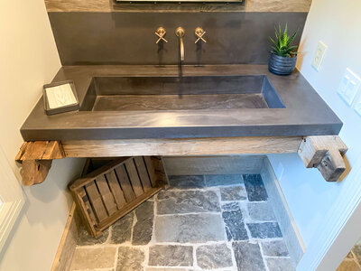 slate concrete trough sink in a rustic guest bathroom