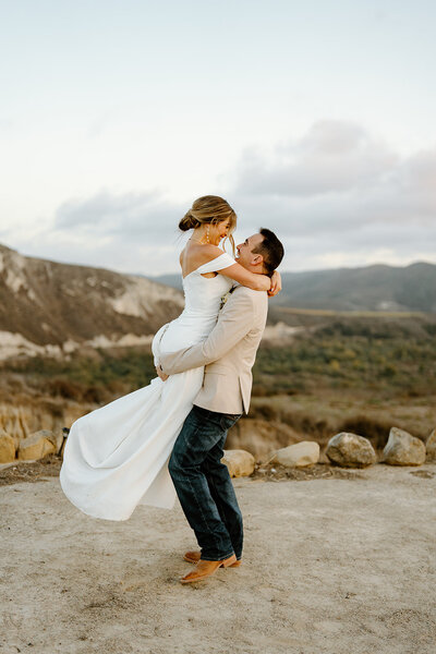 bride and groom standing outside of  venue