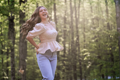 Girl laughing with trees behind her | Senior Portraits