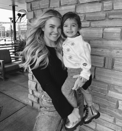 woman holding child smiling