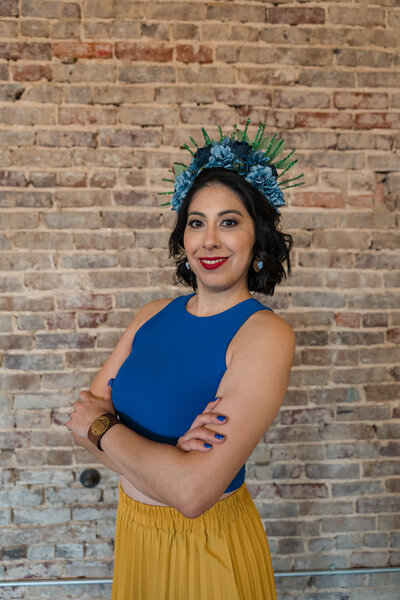 The visionary founder of Soleil Vida Studio, dressed in a stunning yellow skirt and blue top. The passion, creativity, and empowering spirit that drive our craft workshops.