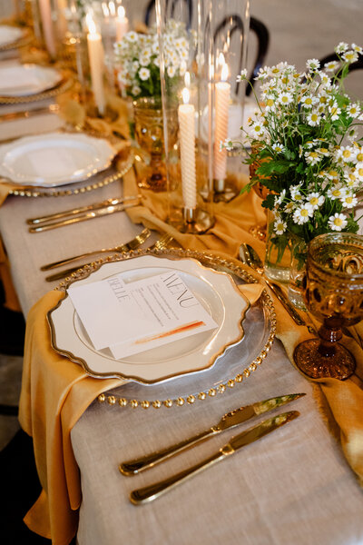 Wedding stylist setting table with a bow