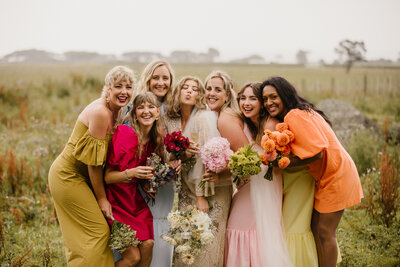 A bride and her bridesmaids all wearing bright colours at a new plymouth wedding