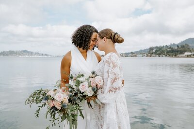 Wives embrace during San Francisco wedding at Seaplane Adventures