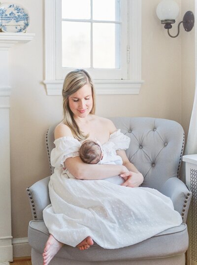 Mother holds newborn daughter in Washington DC newborn  session.