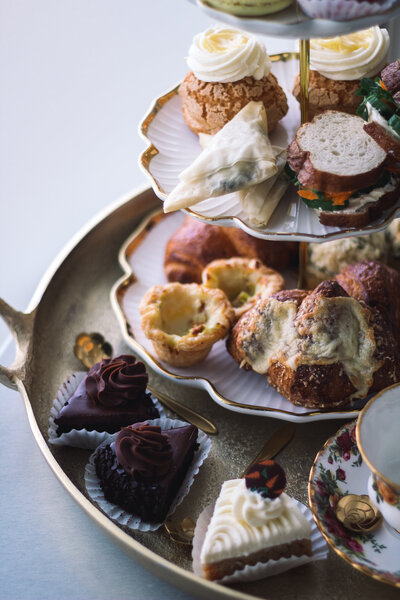 Three-tiered tray with assorted pastries, sandwiches, and desserts served for afternoon tea at Gold Leaf Pastries in Kamloops BC.