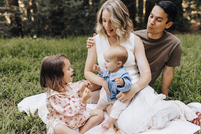 Family Snuggles together as they walk in the hills of Mount Diablo