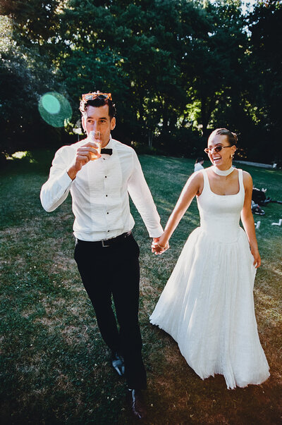 bride and groom hold hands on wedding day in adelaide