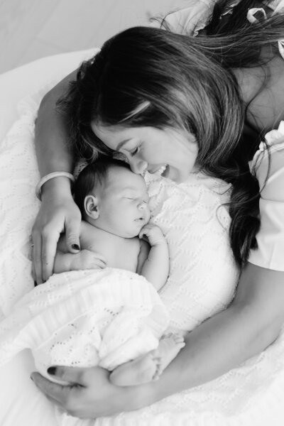 Mom and newborn baby in photography studio on Boise Bench.