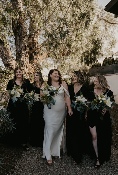 Intimate luxurious Airbnb Wedding. Bridal Party walking with bride.