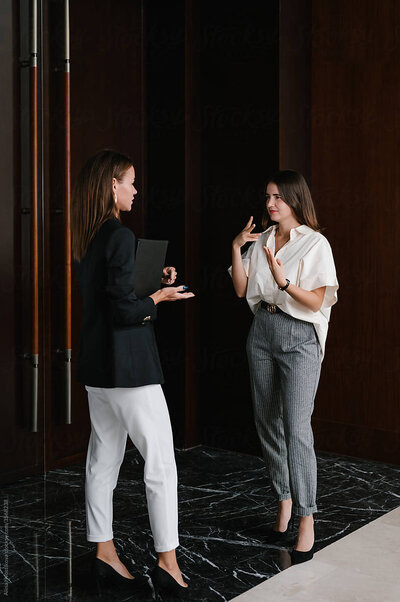 two-business-women-talking-sign-language