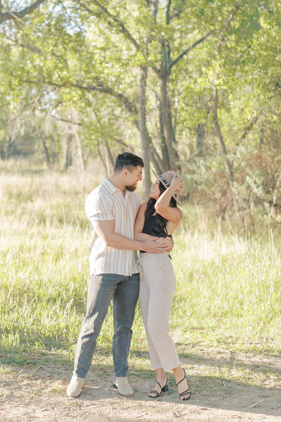 wedding couple kissing in a field with mountain