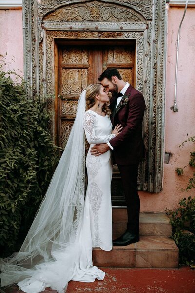 Bride and groom celebrate after their wedding ceremony with a burgundy and pink bouquet  at Lionsgate Event Center North of Denver, Colorado.