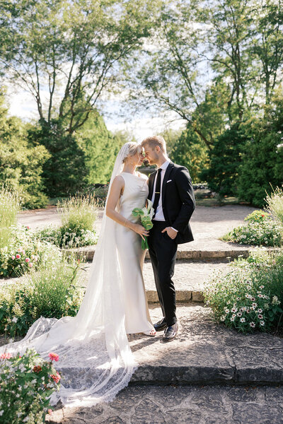 newlyweds pose on steps